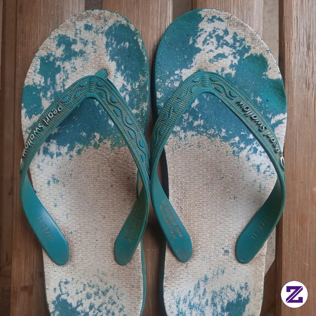 This Photo Features A Top-down View Of A Well-used Pair Of Turquoise And White